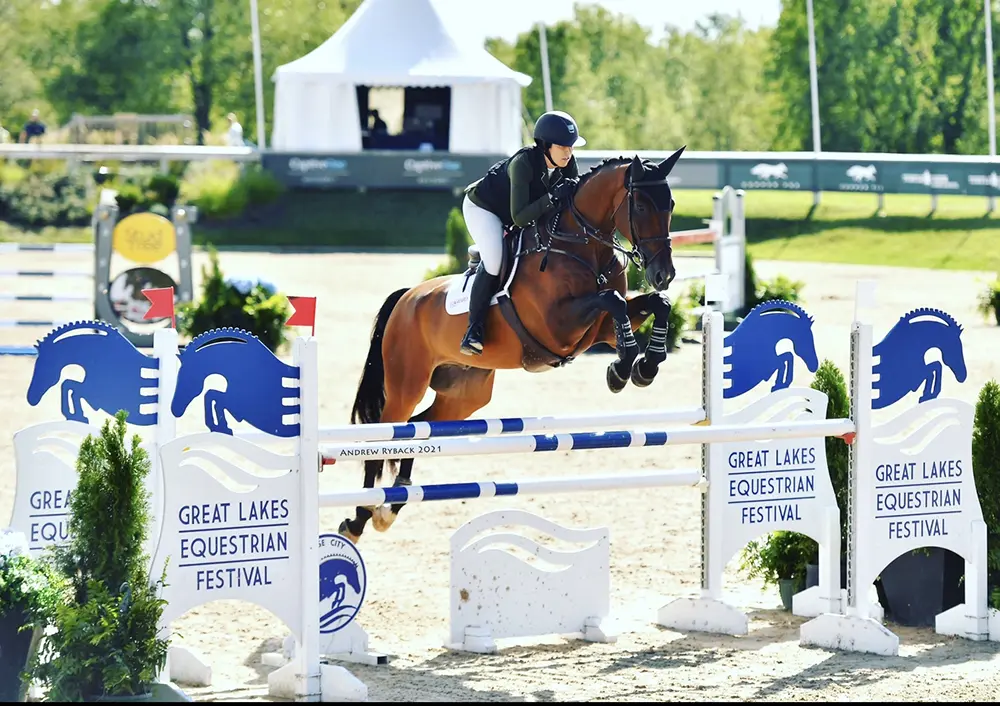 Woman riding horse in competition